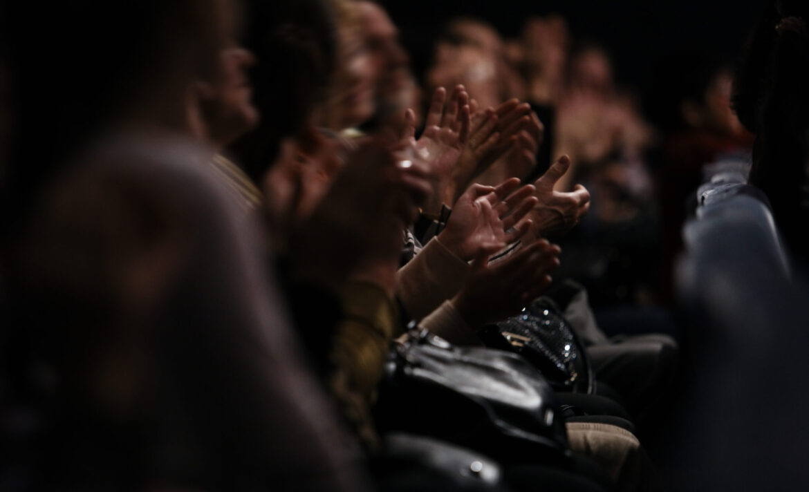 Audience clapping their hands